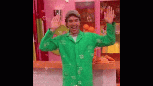 Man In Green Coat Surrounded By Soap Bubbles GIF
