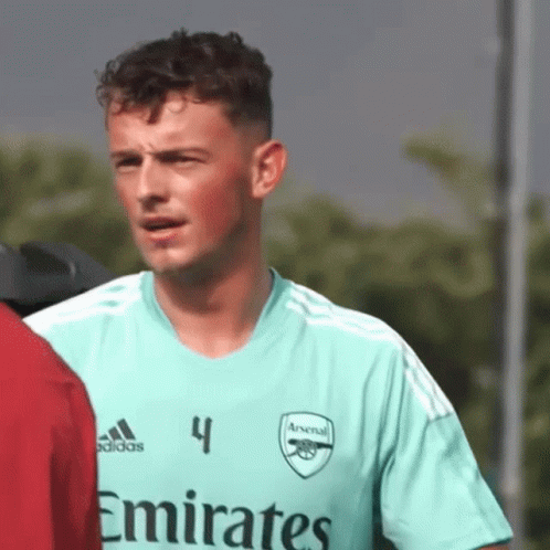 Man in Green Emirates Jersey Beside Another Man