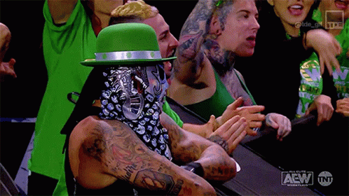 Man in Green Hat and Bandana Applauding Wrestling