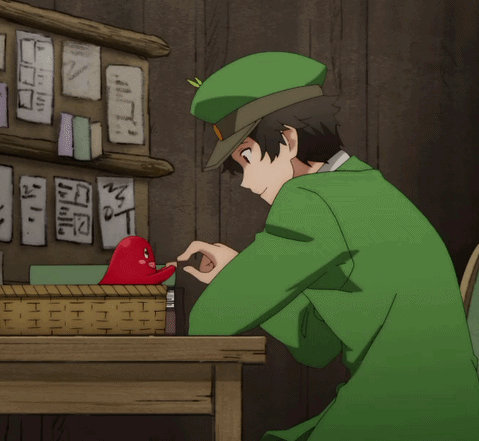 Man in Green Hat Playing With Red Heart at Desk