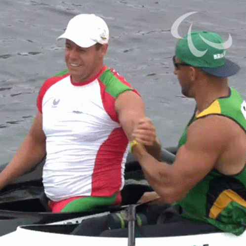 Man in Green Hat with Paralympic Shaking Hands
