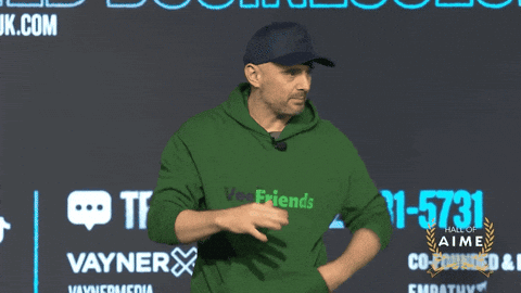 Man In Green Hoodie In Front Of Vayner Wall GIF