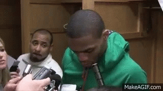 Man In Green Hoodie Interviewed By Group With Microphones GIF