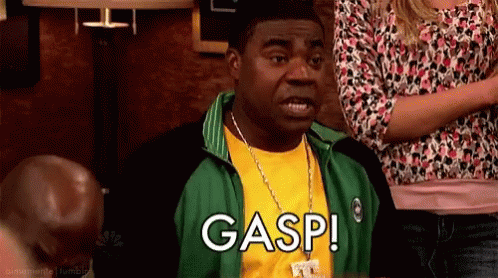 Man in Green Jacket and Yellow Shirt Saying Gasp