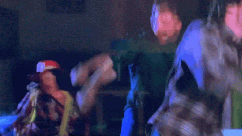 Man In Green Jacket And Yellow Tie Held By Man GIF