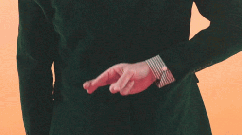 Man In Green Jacket Crossing Fingers GIF