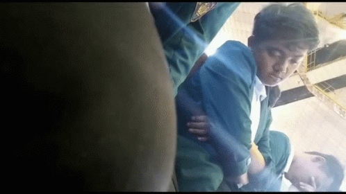 Man In Green Jacket Lying On Floor Eyes Closed GIF