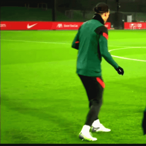 Man in Green Jacket on Green Soccer Field