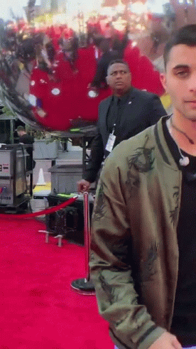 Man in Green Jacket on Red Carpet