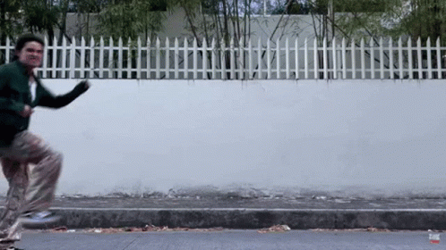 Man In Green Jacket Running GIF
