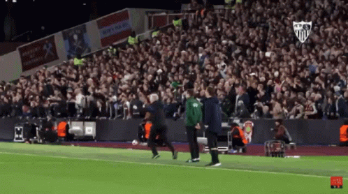 Man In Green Jacket Running On Soccer Field GIF