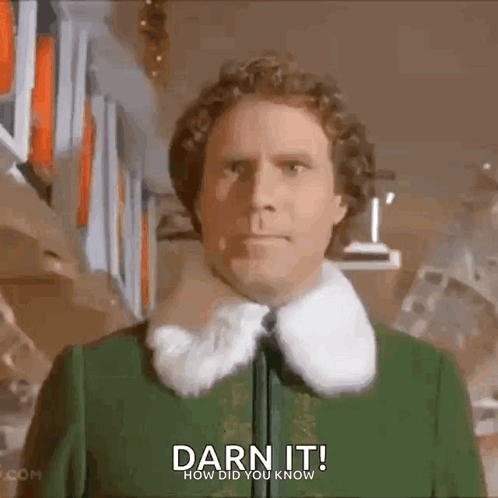 Man in Green Jacket with Fur Collar by Bookshelf