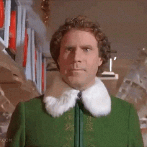 Man in Green Jacket With Fur Collar by Shelf