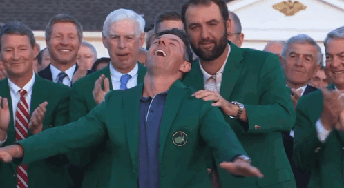 Man in Green Jacket with Golf Badge