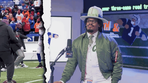 Man In Green Jacket With Letter C At Microphone GIF