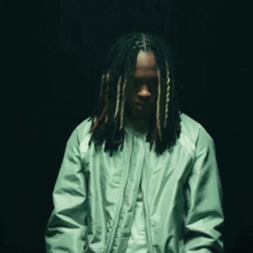 Man in Green Jacket With Long Dreadlocks