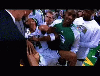 Man in Green Jersey Number 4 Being Carried