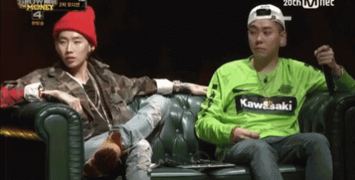 Man In Green Kawasaki Shirt Sitting Next To Man On Couch GIF
