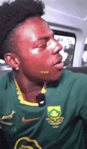 Man In Green Nike Shirt With Yellow Logo GIF