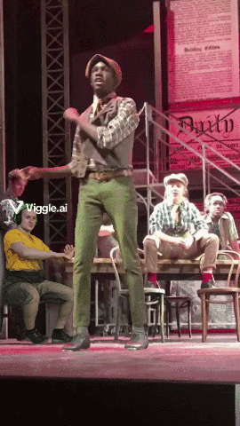 Man in Green Pants on Stage With Faith Sign