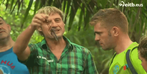 Man in Green Plaid Shirt Holding Snake