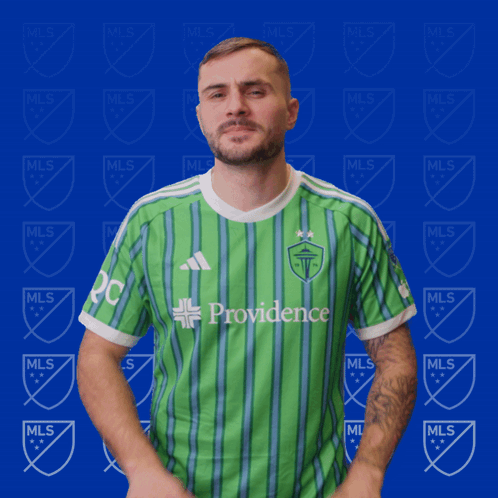 Man in Green Providence Shirt on Blue Background