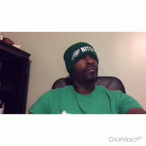 Man in Green Shirt and Beanie Saying Bitch