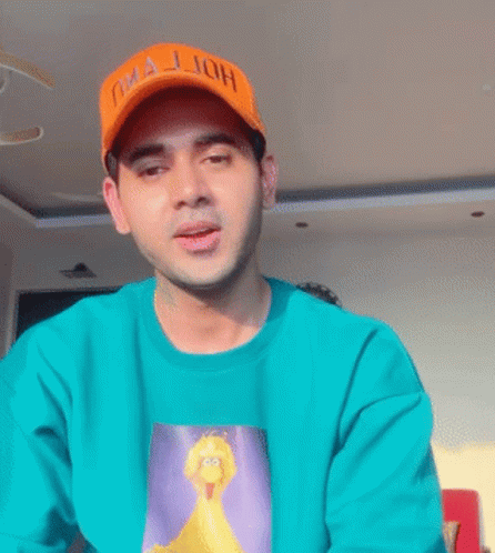 Man in Green Shirt and Orange Oha Jjoh Hat