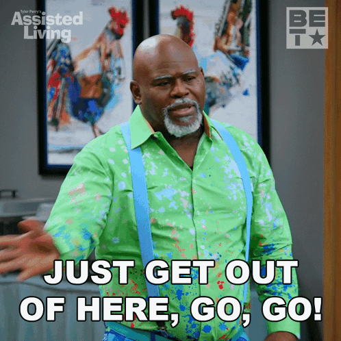 Man in Green Shirt and Suspenders Saying Get Out