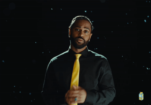 Man in Green Shirt and Yellow Tie with Lemonade Carton