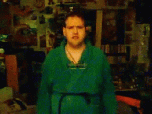 Man In Green Shirt By Ticks Me Off Sign GIF