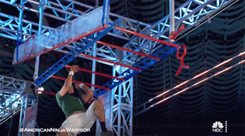 Man in Green Shirt Doing Ninja Warrior