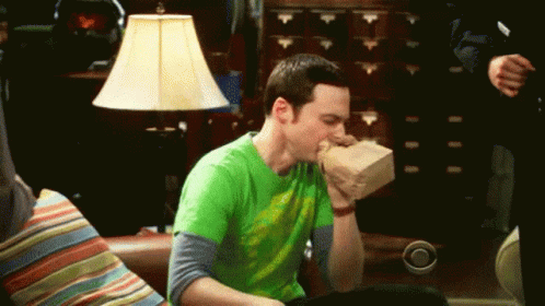 Man In Green Shirt Eating Bag Of Food GIF