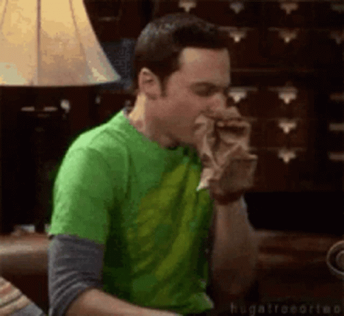 Man in Green Shirt Eating Food