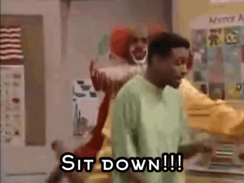 Man in Green Shirt Facing Clown