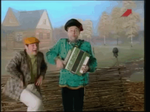 Man in Green Shirt Holding Accordion