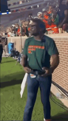 Man in Green Shirt Holding Football