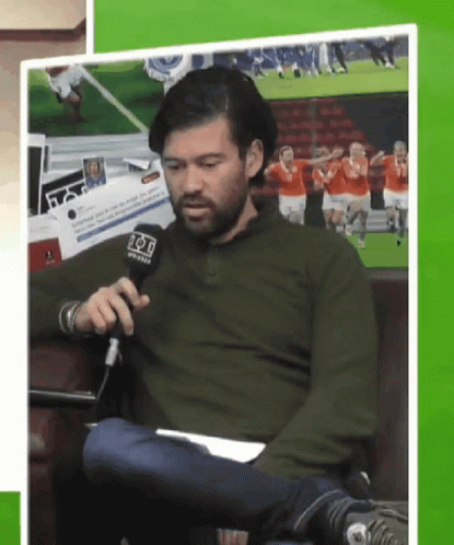 Man in Green Shirt Holding Fox Microphone