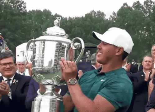 Man In Green Shirt Holding Trophy GIF