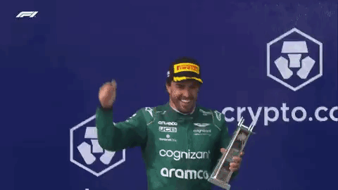 Man In Green Shirt Holding Trophy GIF