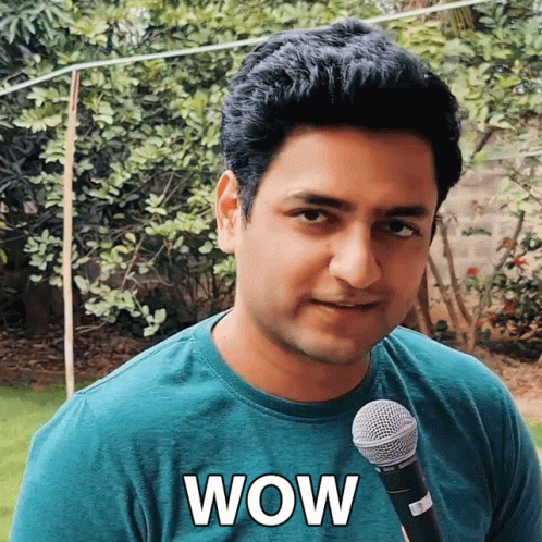 Man in Green Shirt Holding Wow Microphone