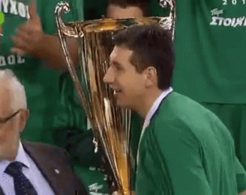 Man In Green Shirt Kissing Gold Trophy GIF