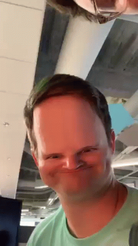 Man in Green Shirt Making Funny Face