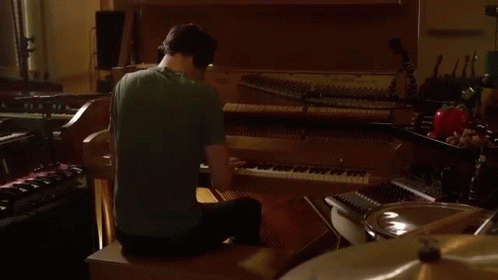 Man In Green Shirt Playing Piano GIF