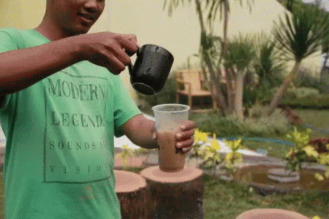 Man in Green Shirt Pouring Coffee Modern Legend Sounds Vision
