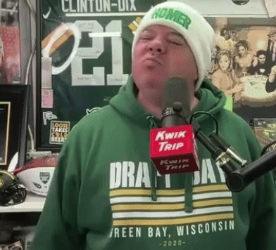 Man in Green Shirt Saying Green Bay Wisconsin Singing Into Kwik Trip Microphone