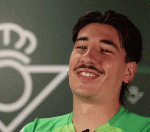 Man in Green Shirt Smiling in Front of Crown