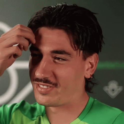 Man in Green Shirt Smiling in Front of Crown