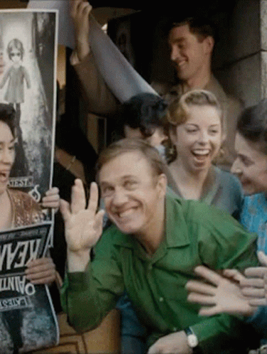 Man in Green Shirt Surrounded by Kevin Signs