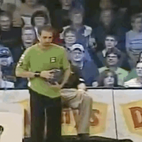 Man in Green Shirt With Letter B